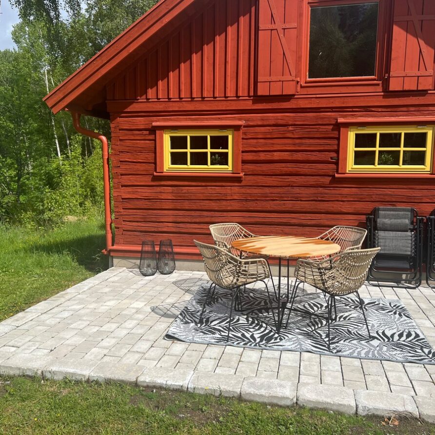 Cottage with lake, dock & boat, open landscape & fields.